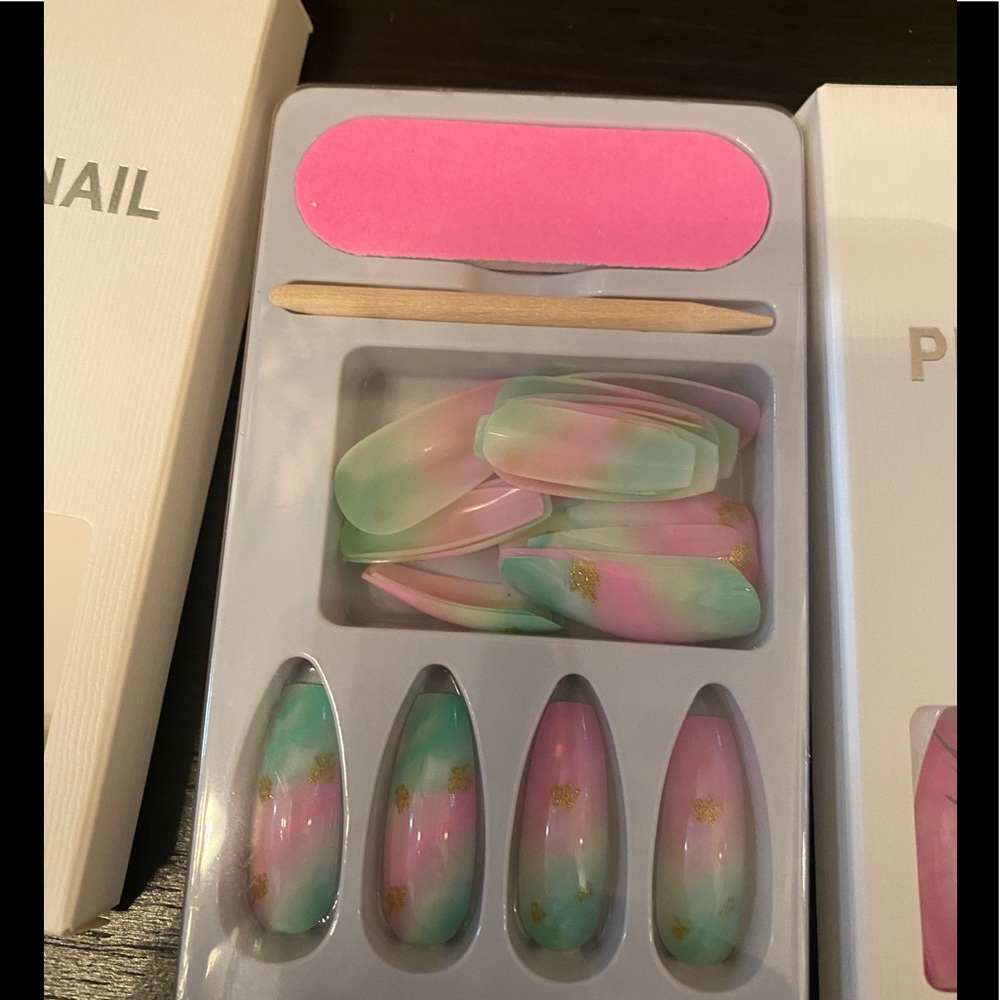 Nail  press set , it is pink Mabel with some black design.